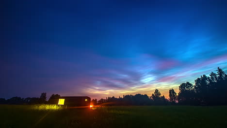 Thermowood-Shed-In-Green-Field-Under-Beautiful-And-Colorful-Sky---timelapse-shot