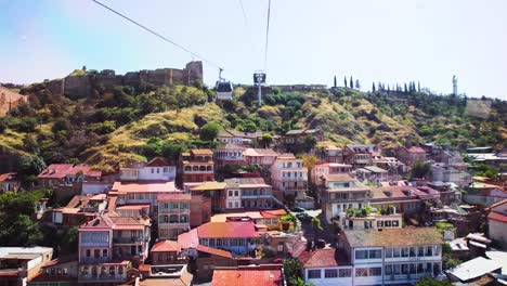 POV-Looking-Out-Of-Window-Of-Cable-Car-Travelling-Over-Tbilisi-In-Georgia