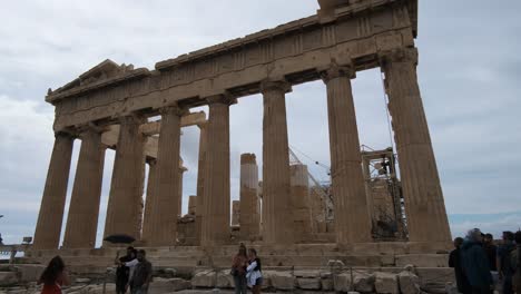 Pan-shot-Parthenon-temple-with-tourist-around-on-the-Acropolis-in-Athens,-Greece-on-10-15-2021