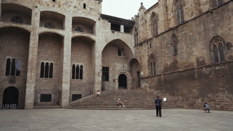 Barcelona---Plaça-del-Rei-with-tourists-sitting-on-the-stone-steps