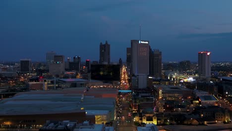 Aerial-drone-view-towards-the-illuminated-cityscape-of-downtown-Columbus,-USA