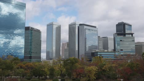 Osaka-City-Building-Skyline-Establishing-Pan-Shot,-Autumn-Season-Japan