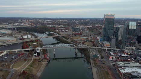 Aerial-drone-view-approaching-Bridges,-dusk-in-cloudy-Nashville,-United-states