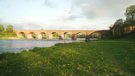 Long-Old-Brick-Bridge,-Kuldiga,-Latvia-Across-the-Venta-River