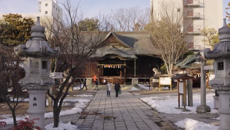 Temple-in-Matsumoto-Japan,-Pan-shot-across-snowy-grounds-in-the-morning