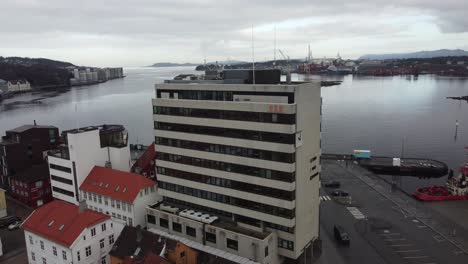 Norled-AS-Headquarter-in-Stavanger-Norway---Office-builing-with-fjord-background-seen---Ascending-reverse-aerial-from-closeup-to-overview
