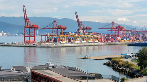 SeaBus-At-Burrard-Inlet-With-Vancouver-Centerm-Container-Terminal-And-Helijet-In-Vancouver,-BC,-Canada