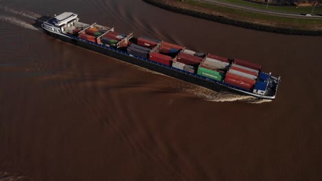Aerial-View-Of-Missouri-Carrying-Shipping-Containers-Along-River-Noord