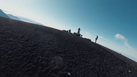 Group-of-hiker-reaching-peak-of-mountain-in-landscape-of-Volcanoes-in-Guatemala,-aerial-FPV-orbit-shot