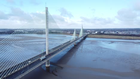 Mersey-gateway-landmark-aerial-view-above-toll-suspension-bridge-river-crossing-high-angle-pull-away-to-wide-shot