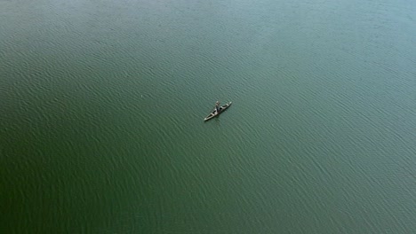 Victoria-Island-Lagos,-Nigeria---15-March-2022:-Drone-view-of-a-fisherman-on-a-fishing-boat-in-Kuramo-waters