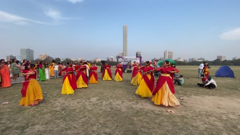 The-celebration-with-dance-and-music-with-colorful-costume-in-the-festival-of-color-called-Holi-or-Basanta-Utsav,-in-spring-at-Maidan,-Kolkata