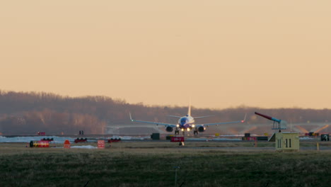 Plane-Takes-Off-At-Sunset-With-Bold-Orange-Sky-In-Washington-D