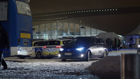 View-of-a-black-car-in-benn-parked-outside-a-hall