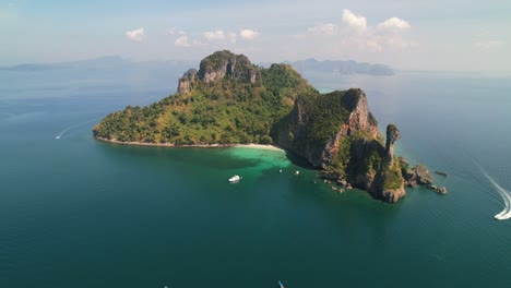 wide-aerial-panoramic-around-tropical-Ko-Kai-Island-in-Krabi-Thailand-on-a-sunny-summer-day-with-a-boat-motoring-around-the-island-towards-the-pristine-white-sand-beaches-and-turquoise-ocean