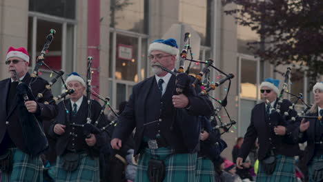 Group-of-bagpipers-in-kilts-playing-in-a-Christmas-parade