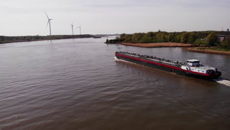 Aerial-Dolly-Over-Waterway-With-View-Of-Da-Vinci-Motor-Tanker-Ship-Navigating-Along-Oude-Maas