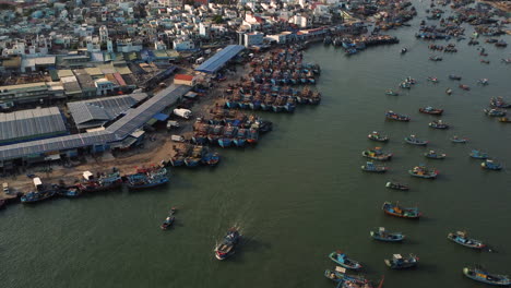 Aerial-pan-up,-fishing-town-harbor-in-Southeast-Asia