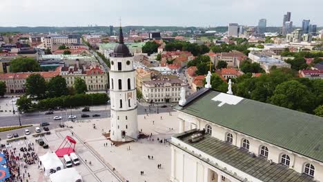 Historical-Vilnius-Cathedral-with-tower-and-skyscrapers-in-horizon,-aerial-view