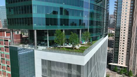 Glass-skyscraper-apartment-office-building-with-green-rooftop-living