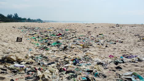 Beach-with-no-one-polluted-with-dirty-plastic-ocean-trash