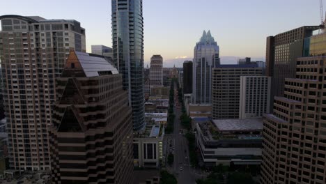 Aerial-view-overlooking-the-Congress-Avenue,-sunny,-summer-evening-in-Austin,-USA---rising,-pull-back,-drone-shot