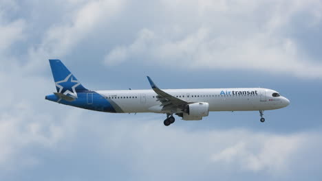 Tracking-pan-of-Airbus-A321-from-Air-Transat-descending-in-cloudy-sky