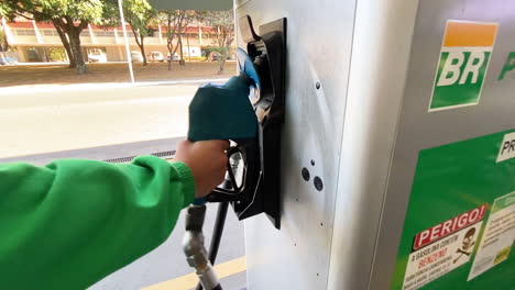 Gas-station-attendant-removes-the-pump-nozzle-from-a-vehicle
