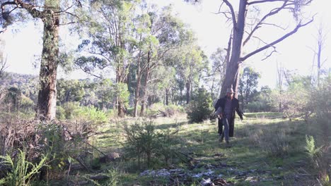A-swagman-carrying-wood-in-the-Australian-bush