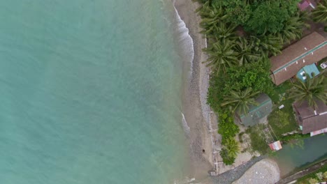 Top-down-view-of-turquoise-beach-sea-water,-beautiful-calming-seashore-and-white-sand