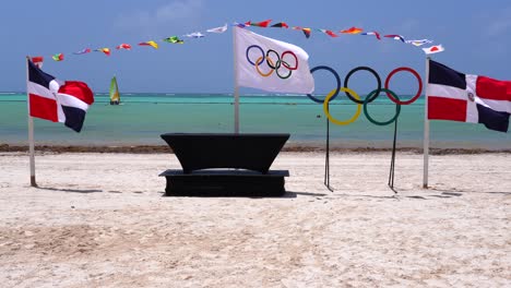 Dominican-Republic,-Olympic,-and-International-flags-wave-in-Caribbean-trade-winds