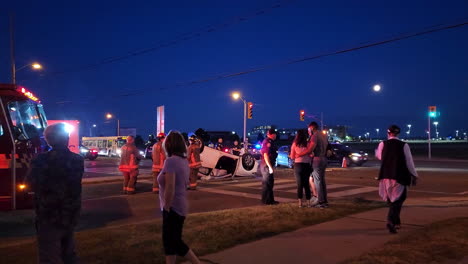 Overturned-vehicle-accident-scene-at-dusk,-dawn,-emergency-personnel-in-attendance