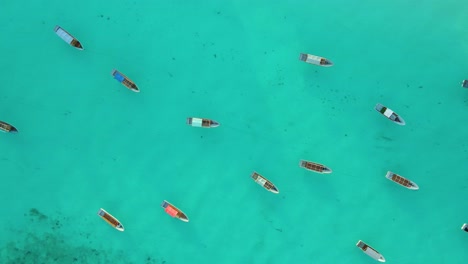 Nungwi-Beach,-Zanzibar---Tanzania---June-18,-2022---Boats-on-the-Indian-ocean-on-a-sunny-cloudy-day-during-sunrise