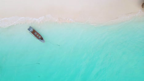 Nungwi-Beach,-Zanzibar---Tanzania---June-18,-2022---Boats-on-the-Indian-ocean-on-a-sunny-cloudy-day-during-sunrise