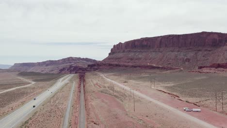 Interstate-Highway-Road-into-Moab,-Utah-Desert---Aerial-Flight
