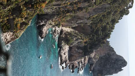 Rugged,-Tall-Sea-Cliffs-on-Coast-of-Tropical-Island-of-Capri,-Italy---Vertical