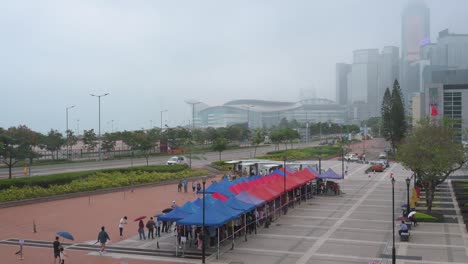 People-queue-in-line-to-receive-PCR-tests-for-coronavirus-from-a-Community-Testing-Centre-truck-to-tackle-the-spread-of-the-virus-and-a-pandemic-wave-near-Hong-Kong's-financial-district