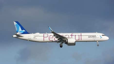 An-Azores-Airlines-aircraft-with-Peaceful-branding-descends-for-landing-on-a-windy-day