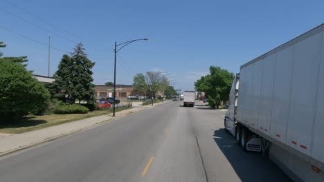 Traveling-in-the-Illinois-Chicago-land-area,-suburbs,-streets,-and-highways-in-POV-mode-passing-park-truck