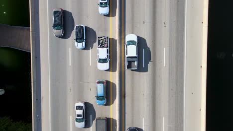 Rush-hour-traffic-with-a-drone-looking-straight-down-moving-along-with-traffic