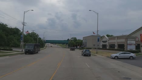 Traveling-in-the-Chicago-Illinois-area,-suburbs,-streets,-and-highways-in-POV-mode-us-30-near-New-Lenox-Illinois-us-flag