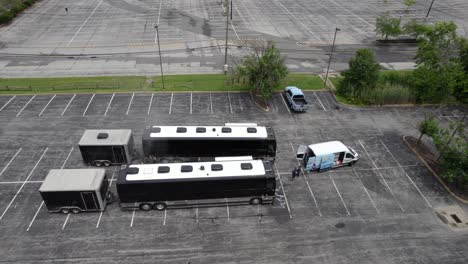 Aerial-view-of-a-team-cleaning-tour-buses-on-a-parking-lot---static,-drone-shot