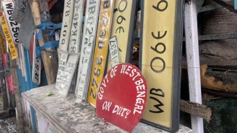 Close-up-video-of-a-stack-of-vehicle-registration-plates-being-painted-in-a-Kolkata's-street