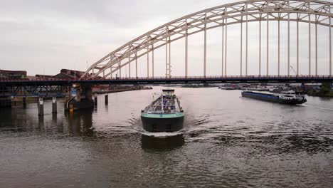 Aerial-View-Of-Ellen-Inland-Liquid-Cargo-Boat-Passing-Underneath-Bridge-Over-The-Noord-On-2-July-2022