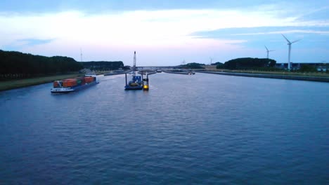 Aerial-View-Amira-Inland-Cargo-Container-Ship-Along-Hollands-Diep-On-Overcast-Moody-Day