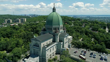 4K-Cinematic-urban-landscape-footage-of-a-drone-flying-around-the-Observatory-Saint-Joseph-in-Montreal,-Quebec-on-a-sunny-day,-behind-Mount-Royal-capturing-a-beautiful-panoramic-view