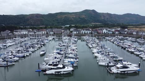 Aerial-view-luxury-holiday-yachts-and-sailing-boats-moored-in-quaint-Conwy-town-marina