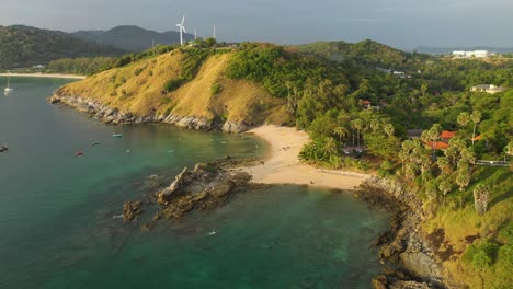 Yanui-beach-aerial-with-palm-trees-and-wind-turbine,-Phuket,-Thailand