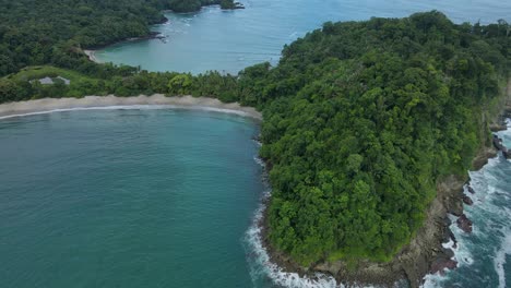 Aerial-drone-shot-Whale-tail-shaped-beach-in-Manuel-Antonio-National-Park,-Costa-Rica
