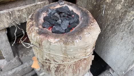 Traditional-Indian-Chulha-aka-stove-in-flame-with-Black-cauldron
